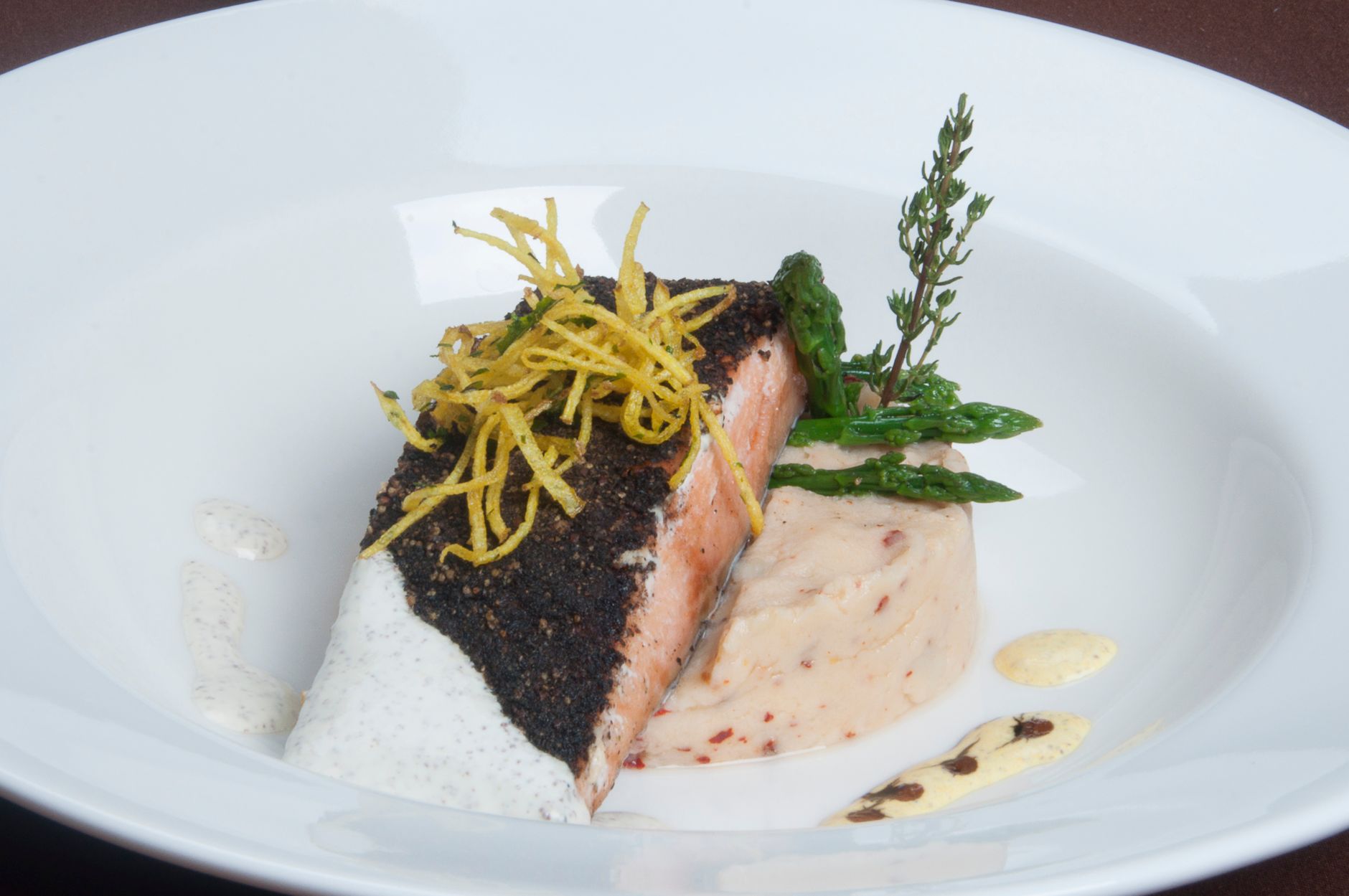 Air fryer salmon fillet with asparagus and lemon on dark slate plate
