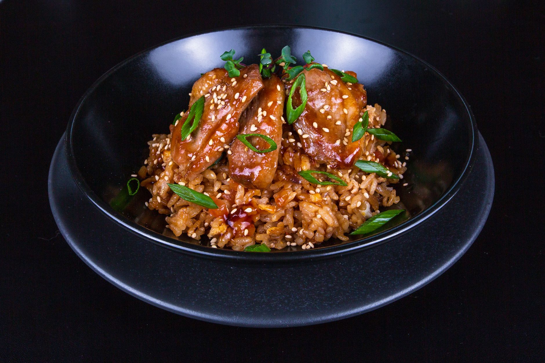 Grilled chicken macro bowl with brown rice and roasted vegetables on dark background