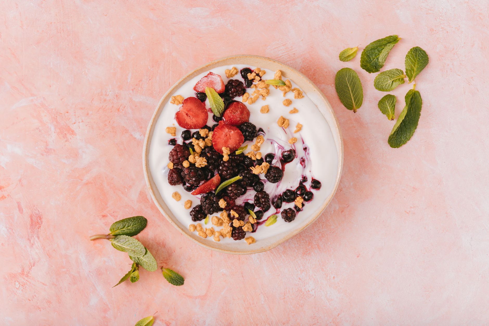 High-protein smoothie bowl with berries, granola and chia seeds in dark ceramic bowl
