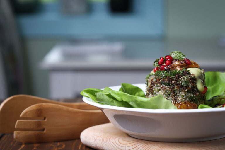 Mediterranean quinoa salad with chickpeas, cucumber and feta in dark ceramic bowl