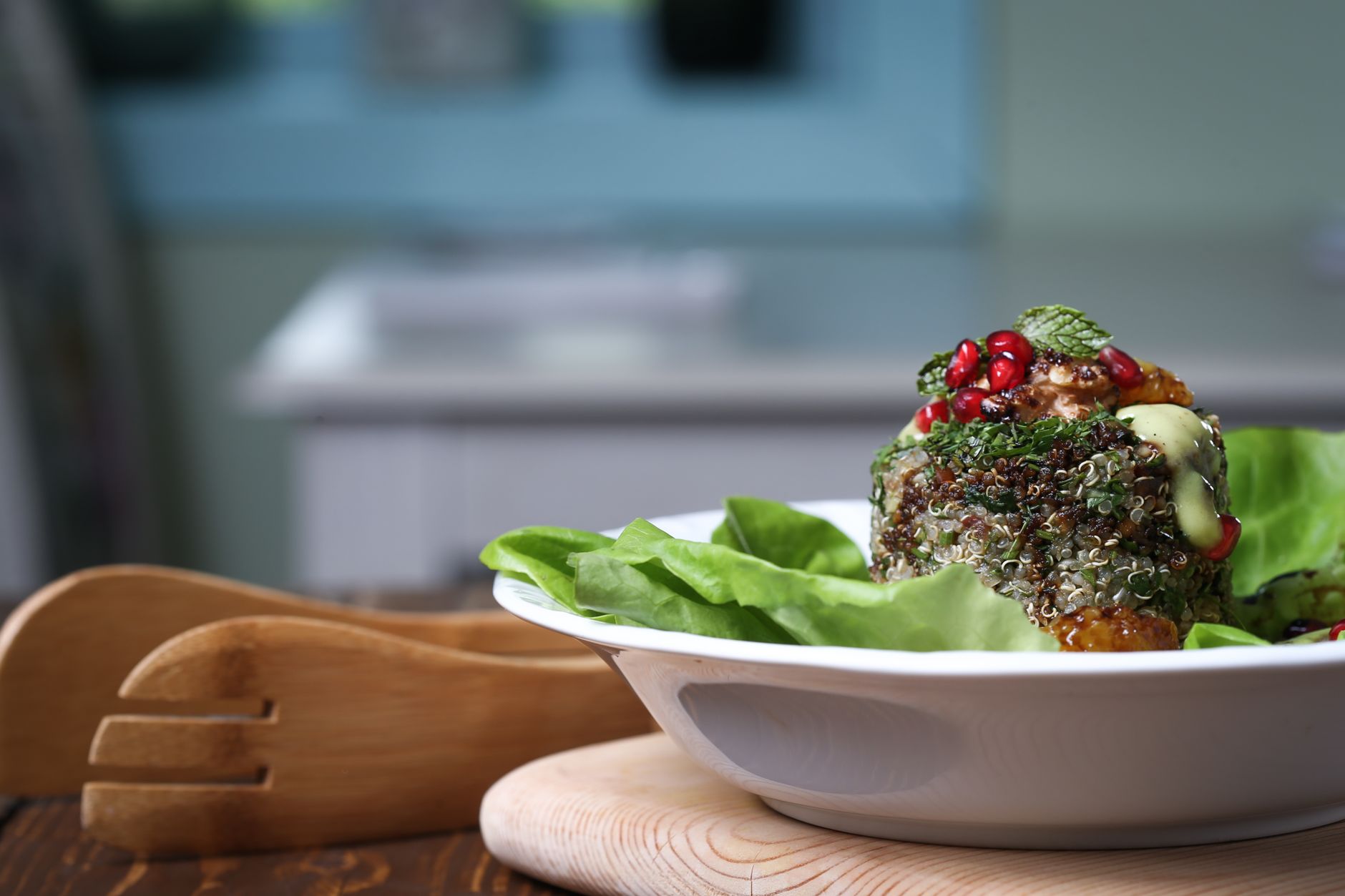 Mediterranean quinoa salad with chickpeas, cucumber and feta in dark ceramic bowl