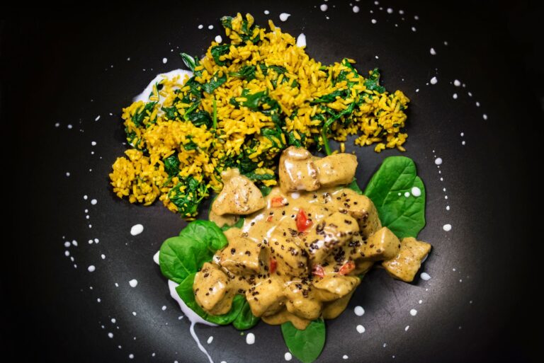 Creamy Tuscan chicken with sun-dried tomatoes and spinach in dark cast iron skillet
