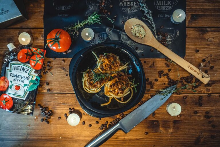 One-pot turkey bolognese with rigatoni and fresh basil in dark bowl